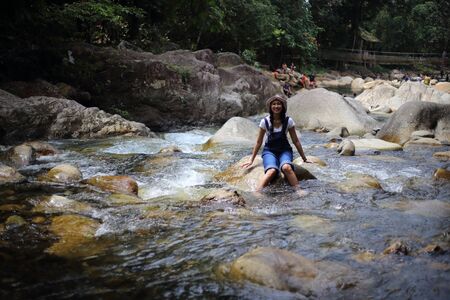 Women playing in fun at Khlong Phaibun Waterfall, Chanthaburi, Thailandの写真素材