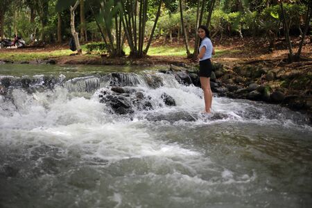 Woman and Nam Tum waterfall in Chanthaburi at thailandの写真素材
