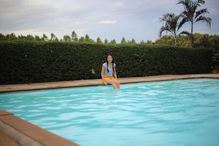 Women enjoying playing in the poolの写真素材