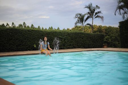 Women enjoying playing in the poolの写真素材