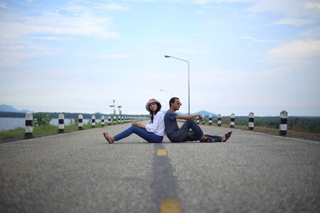Women and men sitting on the streets of the reservoirの写真素材