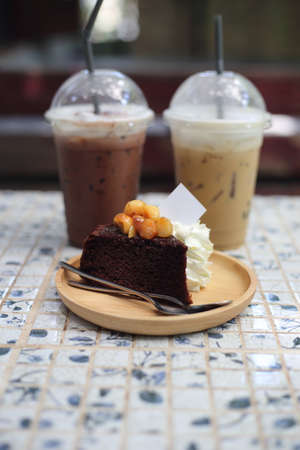 Chocolate cake with ice coffee in coffee shop, Thai dessert.の写真素材