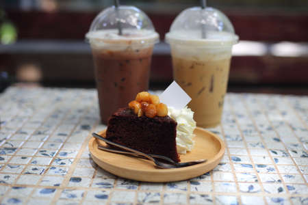 Chocolate cake with ice coffee on table at coffee shop, stock photoの写真素材