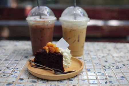 Coffee and chocolate cake with ice coffee in coffee shop.の写真素材
