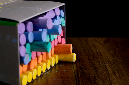 Multi color chalks on black background for copy spaceの写真素材