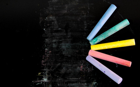 Multi color chalks on black background for copy spaceの写真素材