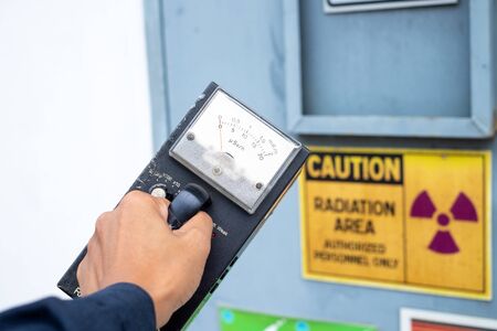 Supervisor use the survey meter to checks the level of radiation in the radioactive zoneの写真素材