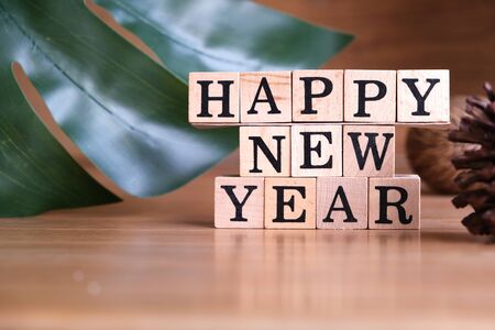 Wooden cube boxes show Happy New Year on wooden backgroundの写真素材