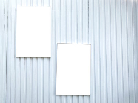 A white wall with white picture frames mock up hanging so that the product can be placed in the...