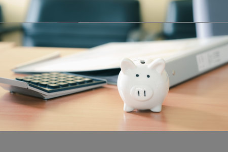 Stacking coins pile and white piggy bank for savings with money and planning step up to growing, Saving money for retirement fund and the future plan concept.の写真素材