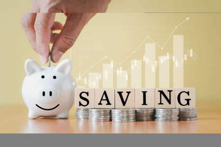 Stacking coins pile and white piggy bank for savings with money and planning step up to growing, Saving money for retirement fund and the future plan concept.の写真素材