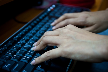 Hands typing on the keyboardの写真素材