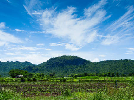 mountains green grass and blue sky landscapeの写真素材
