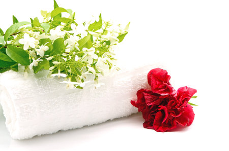 Tropical white and fragrant flower, Wild Water Plum (Wrightia religiosa) and red Hibiscus with towel on spa themeの写真素材