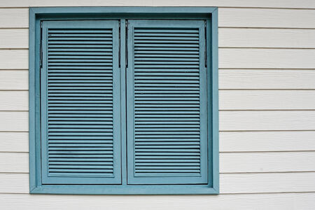 Beautiful cyan wooden window on a white wood backgroundの写真素材