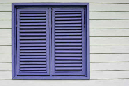 Beautiful purple wooden window on a white wood backgroundの写真素材
