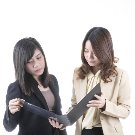 Two asian business woman in office, discussing profileの写真素材