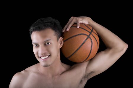 Asian young basketball player on black backgroundの写真素材