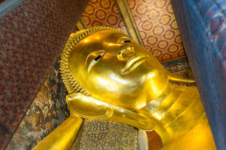 Reclining Buddha gold statue face in Wat Pho, Bangkok, Thailandのeditorial素材