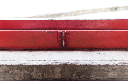 Old metallic latch on a red door