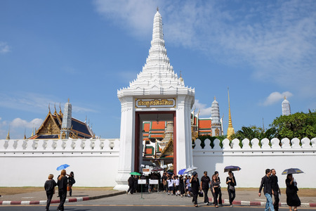 BANGKOK, THAILAND - OCT 20, 2016 : Crowds of mourners with black clothing walk out the door of Grand Palace and Wat Phra Keaw, the landmark in Bangkok, Thailandのeditorial素材