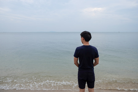 Behind a man looking at the sea in Thailandの写真素材