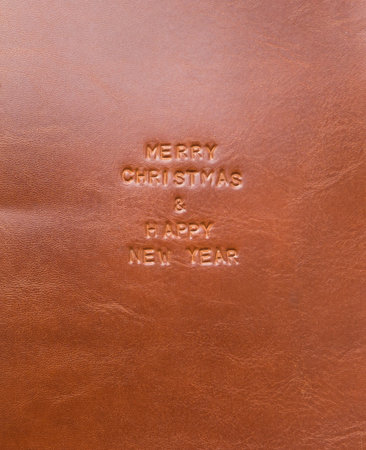 Merry Christmas and happy new year, text on leather