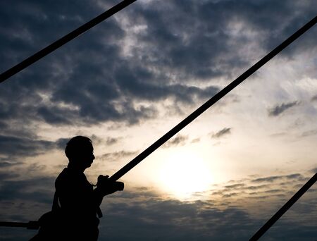 A man photographer taking photo in the morningの写真素材