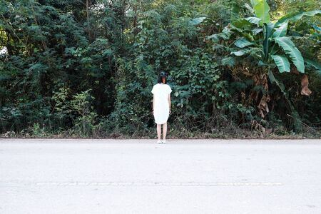A girl standing in front of forestの写真素材