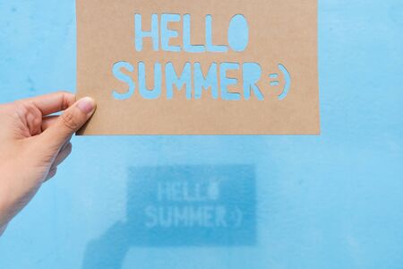 Shadow of text "Hello Summer" on blue background, summer timeの写真素材