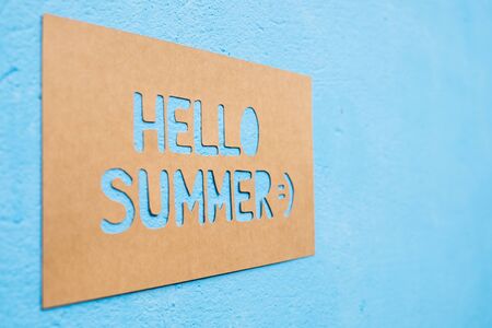 Text Hello Summer on paper with blue background, summer timeの写真素材