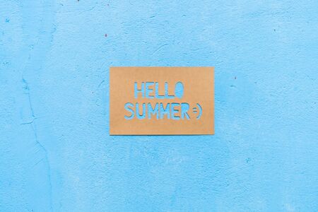 Text Hello Summer on paper with blue background, summer timeの写真素材
