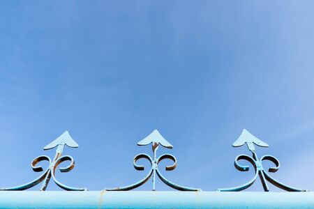 Blue metal fence with clear sky backgroundの写真素材