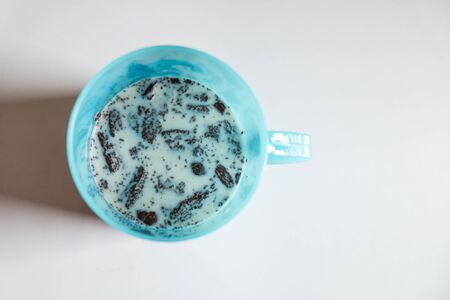 Pile of brownies with milk on white tableの写真素材