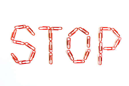 Red stop sign from paper clips on white backgroundの写真素材