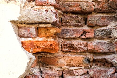 Broken concrete wall of the house show old brick wall insideの写真素材