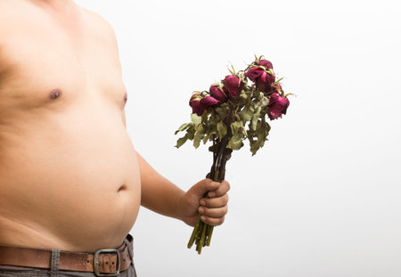 Close up abdomen and withered rose on white backgroundの写真素材