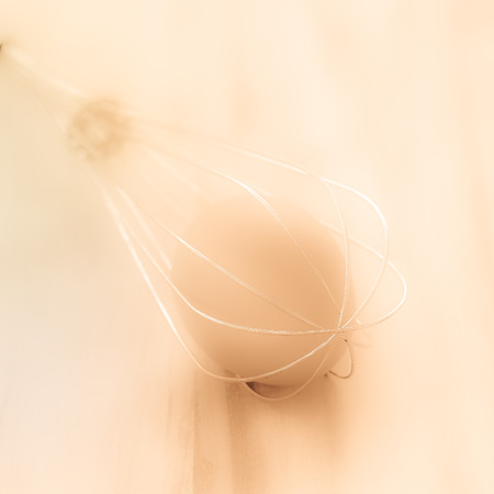 Still life egg in whisk. selective focus and use soft light in brown tone.の写真素材