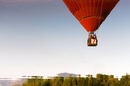 Water reflection colorful hot air balloon in the blue sky.の写真素材