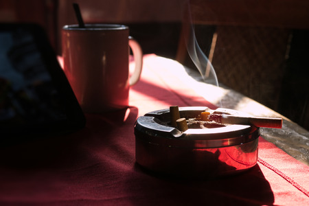 Cigarette on stainless ashtray. on moring light.の写真素材