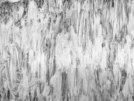 Grungy white brush paint background with grain.