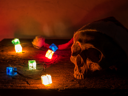 Still life skull wear santa claus hat with gift blinker light.の写真素材