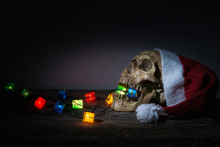 Still life skull wear santa claus hat with gift blinker light.の写真素材