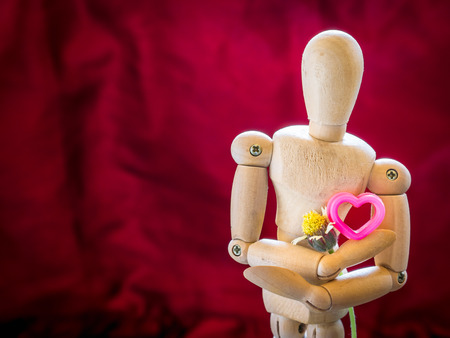 Still life wooden puppet and pink heart. concept everyting have love and heart.の写真素材