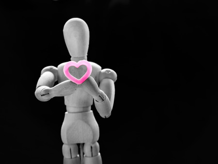 Still life wooden puppet and pink heart. concept everyting have love and heart.の写真素材
