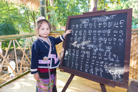 CHIANGRAI -THAILAND DECEMBER 7: Unidentified girl Tai Lue in Tribal dress and Tai Lue language on December 7, 2015 in Chiangrai,Thailandのeditorial素材