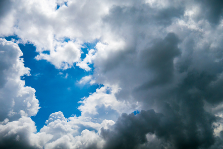White clouds and black cloudy befor raining.の写真素材