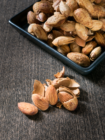 Group almond on black dish and cloth.の写真素材