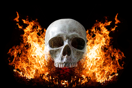 Head skull in flame on dark black background. the symbol of dead.