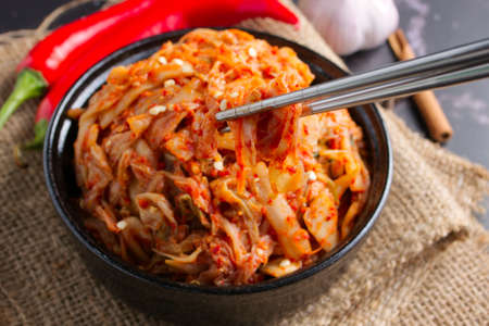 Korean food, Cabbage kimchi in black dish set on dark background.の写真素材
